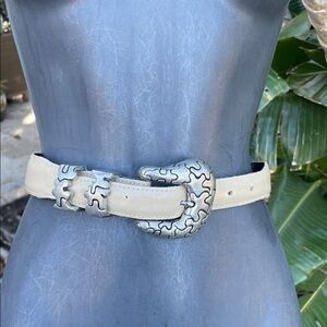 calfskin leather belt with ornate abstract, silver buckle,and close
